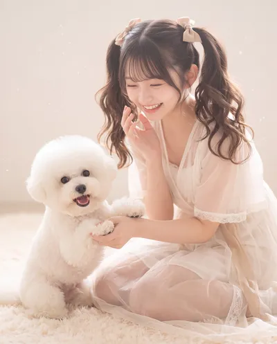 Rino in a sheer cream dress with ribboned pigtails, kneeling on a soft rug and holding a white dog's paw
